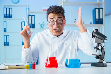 Funny mad chemist working in a laboratory