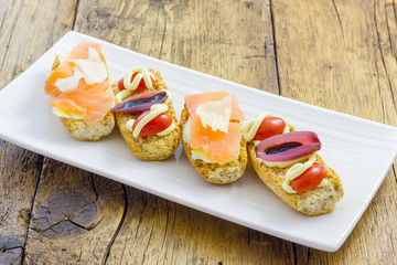 Bruschette with salmon and red onion