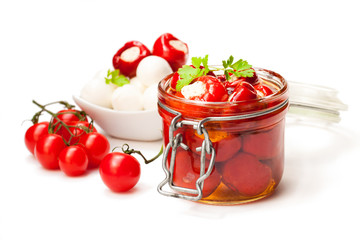 Marinated  cherry tomatoes stuffed with mozzarella and spices isolated on white