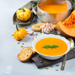 Fall autumn roasted orange pumpkin carrot soup with garlic