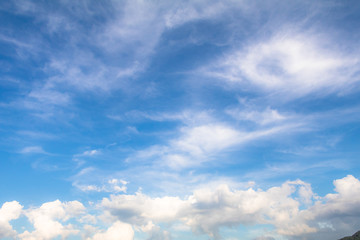 Obraz premium Clear blue sky background with white clouds.