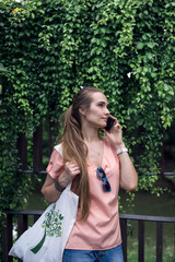 Girl talking on the phone in the garden