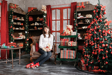 Portrait of pretty girl on background Christmas tree.