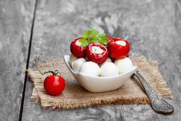 Marinated  cherry tomatoes and mozzarella on wooden table