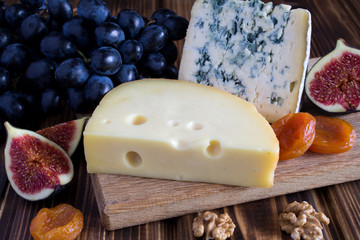 Cheese plate on the brown wooden background