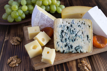 Cheese plate on the wooden background