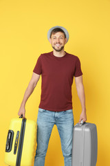 Man with overweight luggage on colorful background