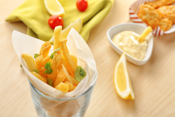 Potato chips rolled in paper on table