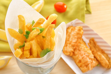 Potato chips rolled in paper on table, closeup