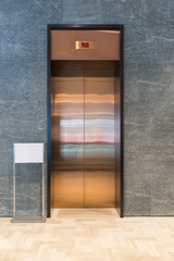 Modern elevator with sign white board blank and gray marble wall