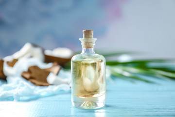 Bottle with coconut oil on wooden table