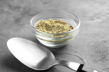 Bowl of hemp protein powder and spoon on table