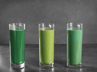 Glasses of different smoothies on table