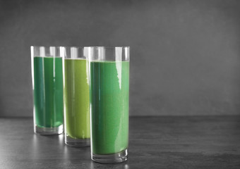 Glasses of different smoothies on table
