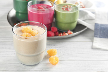 Glass of fresh protein smoothie on table