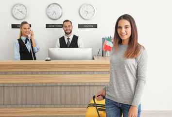 Young woman and two receptionists in hotel