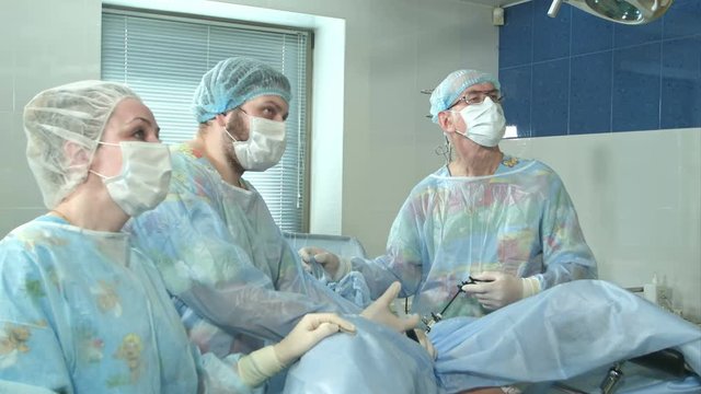 Team of doctors working together during a surgery in an operating room at a hospital