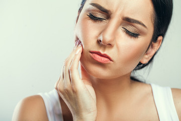 Tooth Pain And Dentistry. Beautiful Young Woman Suffering From Terrible Strong Teeth Pain, Touching Cheek With Hand. Female Feeling Painful Toothache. Dental Care And Health Concept. High Resolution