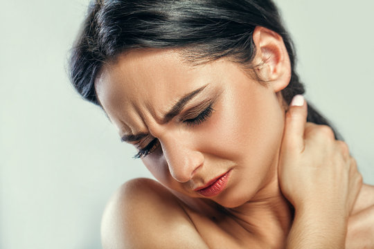 Tired Neck. Beautiful Young Woman Suffering From Neck Pain. Attractive Female Feeling Tired, Exhausted, Stressed. Girl Massaging Painful Neck With Hand. Body And Health Care Concept. High Resolution