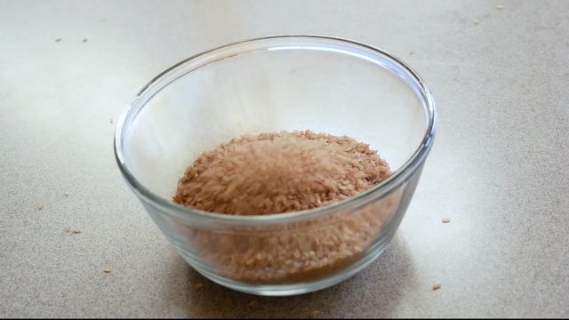 Red Rice being poured into a bowl.
