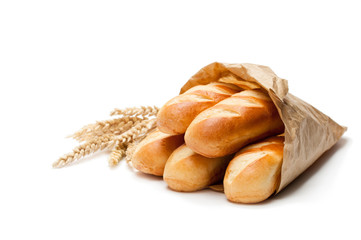 Mini  loaf bread in paper bag and wheat ears isolated on white background