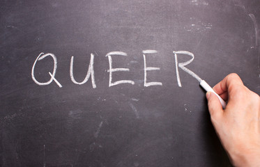 QUEER word chalk on a blackboard