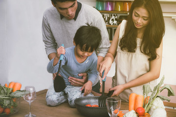 Families are happy to cook together in the kitchen.
