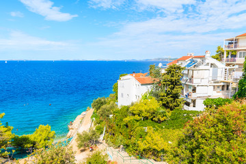 Fototapeta na wymiar Holiday houses with apartments on sea coast near Primosten town, Dalmatia, Croatia
