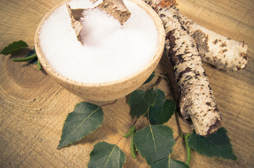 Xylitol - sugar substitute. Birch sugar on wooden background.