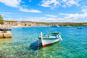 Fototapeta na wymiar Colorful fishing boat on turquoise sea water in Primosten port, Dalmatia, Croatia