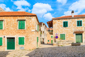 Fototapeta na wymiar Street with typical stone houses in Postira old town, Brac island, Croatia