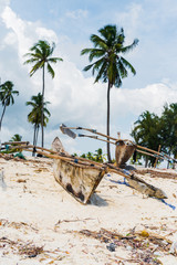 old wooden fishing boats with paddles on a beach of fishing village in Zanzibar