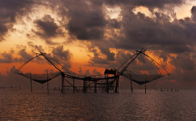 unique dip fishing net used by fishermen and women for catching prawns from the freshwater lake located in Phatthalung province, Thailand