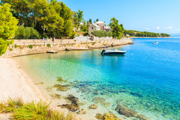 Fototapeta premium Boat on turquoise sea water of beach in Sumartin town on Brac island, Croatia