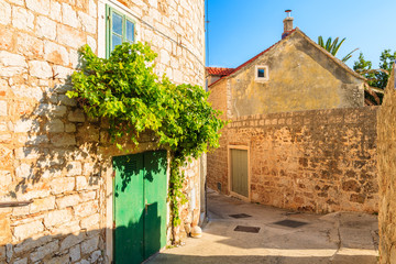 Narrow street with historic houses in old town of Bol, Brac island, Croatia