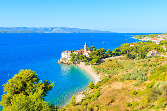 View of beautiful bay with beach and Dominican monastery in Bol town, Brac island, Croatia