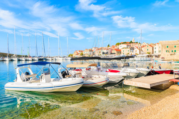 Fototapeta na wymiar Boats on beach in Primosten port, Dalmatia, Croatia