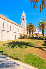 Fototapeta na wymiar Church building with palm trees in old town of Trogir, Dalmatia, Croatia