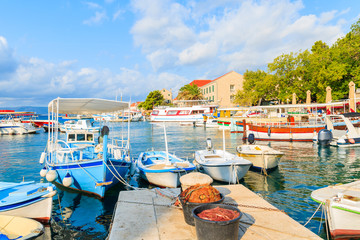 Baskets with fishing nets and traditional boats in Bol port, Brac island, Croatia