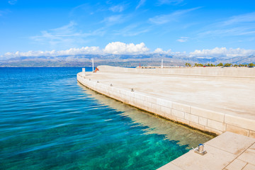 Crystal clear sea in Supetar port with mountains on mainland visible in distance, Brac island, Croatia