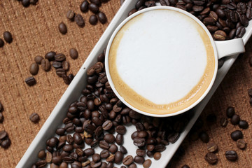 hot coffee on coffee beans