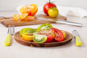 Salad of Colorful fresh tomatoes. Organic and healthy eating concept. Seasonal autumn vegetables