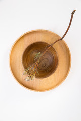 Wooden plate with a dry branch