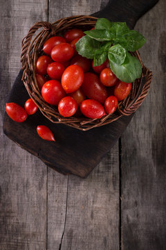 Colorful tomatoes, red cherry tomatoes , autumn background. vintage wooden background