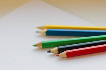 Colorful pencils on white paper