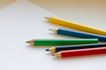 Colorful pencils on white paper 