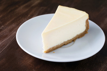 Plain cheesecake slice on white plate