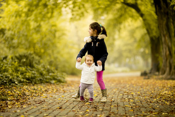 Two little girls at autumn park