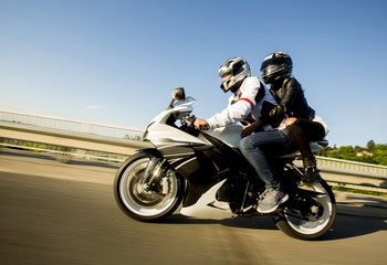 Young man and a woman on a motorcycle