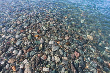 pebbles on the seabed transparent water